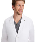 Portrait of man wearing Men's White Lab Coat With 5 Pockets, 360 Degree Stretch, Knit Details, Relaxed Fit, 34.5 Inch Back Length