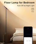 Smart RGB Floor Lamp With Alexa And Google Home, WiFi App Control displayed in a bedroom setting with remote dimming feature shown on phone app