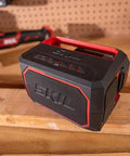 Heavy Duty Portable Bluetooth Speaker With Kickass Bass And Wireless Audio placed on a wooden surface with tool background.