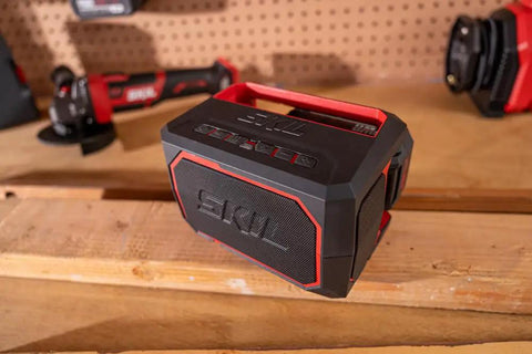 Heavy Duty Portable Bluetooth Speaker With Kickass Bass And Wireless Audio placed on a wooden surface with tool background.