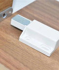 Magnetic Push Latch Cabinet Hardware with push to open touch lock on wooden surface, durable metal construction, stealth release.