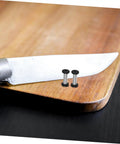 Top Tier Flat Head Knife Handle Screws Coupled With Heavy Gauge Stainless Steel Bolts Lock Down Blade Stability With Quick Thread Adjustments Tight Grip Badass Toolsmith Supply Pack resting on wooden cutting board beside knife.