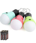 Three Pack Portable LED Camping Lights With Three Modes High Low And Strobe Lightweight ABS Bulbs In Green Teal Pink Ideal For Kids Adventures Camping Emergencies Includes 3 AAA Batteries shown with included batteries.