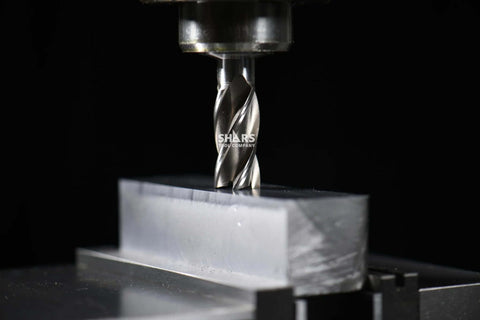 Shars 3/8 in HSS 4-flute end mill; front view with SHARS logo on flute cutting a metal block.