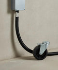 Built Tough Workhorse Corrugated Flexible Conduit Pipe With Compression Fitting Connector For Electrical Cable Routing And Wiring Harness Protection Rated At 20 Bar Pressure In A Sturdy 19 Millimeter Coil, installed with a gray junction box.