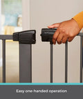 Person operating Extra Tall And Wide Pressure Mounted Baby Gate For Doorways, Adjustable 29.75 To 52 Inches Wide, Graphite Finish.