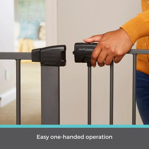 Person operating Extra Tall And Wide Pressure Mounted Baby Gate For Doorways, Adjustable 29.75 To 52 Inches Wide, Graphite Finish.