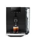 Step Up Your Home Brew Game With This Compact Automatic Coffee Machine Featuring A Pro Aroma Grinder And Super Simple Programmable Settings In Classic Metropolitan Black Color. Compact espresso machine with a glass of coffee.