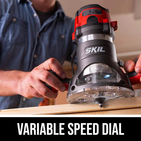 Close-up of a person using a Heavy Duty 10 Amp Fixed Base Corded Router With A Beefy Two Point Zero Horsepower Motor And Variable Speed Control for precise woodworking.