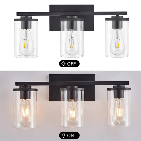 Three Light Vanity Light Fixture With Clear Glass Shades Slick Matte Black Wall Sconce For Bathroom Mirror Hallway Bedroom And Living Room Farmhouse Style Vanity Lighting, shown on and off.