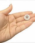 Rock Solid 5 Pack Nylon Pulley Wheels With Quiet Ball Bearings For U Groove Tracks held in hand, showcasing the size and detail.