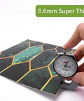 Close-up of caliper measuring thickness of Holographic Emerald Art Deco Peel And Stick Backsplash Tiles Self Adhesive PVC Wall Tiles.