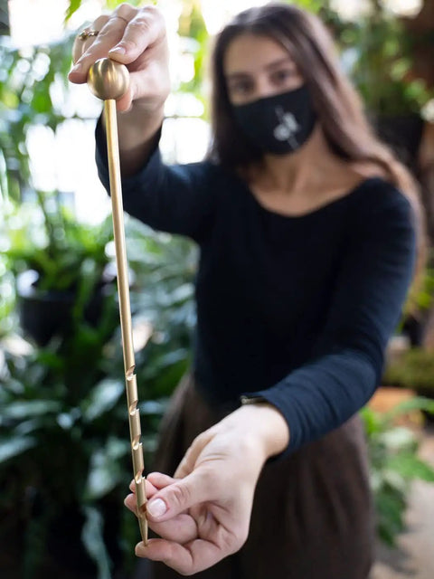 Unlimited Brass Soil Probe With Moisture Meter And Sampler No Batteries Required Root Aerator And Plant Water Monitor For Pots And Indoor Gardens For Potted Plants And Home Gardeners brass probe held over indoor plants