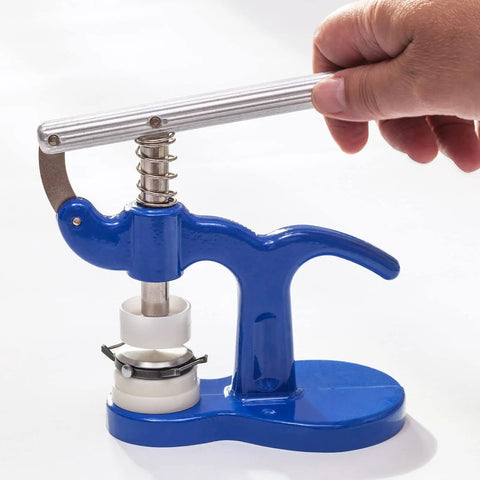 Hand using 8 Piece Watch Case Press Die Kit With Nylon Fitting Dies for Tabletop Capping Machine in blue frame setup