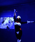 Dancer in glowing costume under 180W UV LED Par Light With DMX Control, Pro Blacklight Strobe And Wash Fixture For Glow Parties Concerts