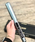 Hand holding Extreme Nano Titanium Hair Straightener With Floating Plates, fast heating, 250C, 110 Volt, salon quality