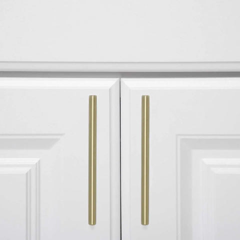 Gold Champagne Euro Bar Cabinet Handles 7 And 3 Eighths Inch Long 5 Inch Hole Center One Half Inch Diameter on white cabinets