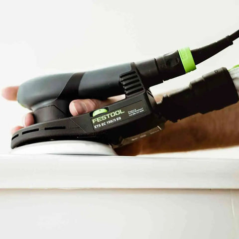 Topshelf Random Orbit Sander With Stepless Speed Control delivering smooth finishes on a wooden surface during refinishing.