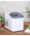 High Performance Countertop Ice Maker Portable With Built In Storage Bin For Rapid Ice Cubes Kitchen Home Bar Entertainment RV Camper Travel Compact Self Contained Unit Energy Efficient Smooth Chill Results on wooden table with drinks.