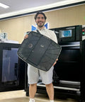 Person holding large 3D printed part in front of MD-1000D Industrial Grade 3D Printer With Fully Enclosed Cabinet, 1000mm build volume.
