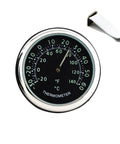 Round car dashboard thermometer with chrome bezel, black dial, and white air vent clip.