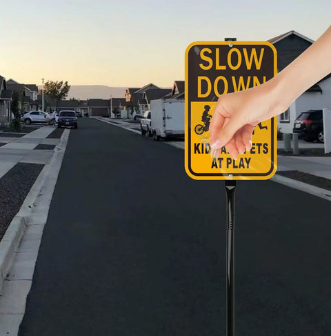 Slow Down Kids At Play Safety Signs In Yellow And Black Reflective Aluminum 14 By 10 Inches installed in residential area