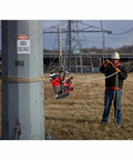 Portable Lineman Magnetic Drill Kit suspended beside a worker, used for heavy-duty metal cutting on job site.