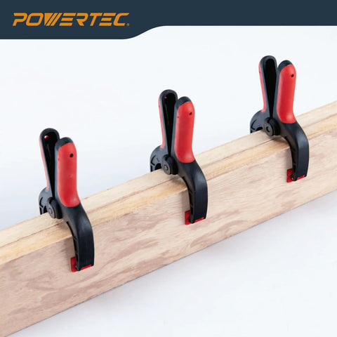 10 Pack Mini Spring Clamps with 1 Inch Opening and Pivoting Jaw Pad on a Wooden Plank