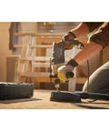 Worker using Two Speed Hammer Drill With 8.5 Amp Motor, Auxiliary Handle With Built-In Depth Gauge, And Slip Clutch for drilling