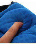 Close-up of blue padded fabric being pressed with a finger, showing texture and cushion.