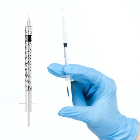 100 Pack 1ml Syringe With 30 Gauge Half Inch Needle Individually Wrapped Pro Grade Lab Supplies For Precision Dosing Easy One Hand Use Smooth Inner Wall Airtight Plunger Ready For Bulk Medical And Scientific Tasks, gloved hand holding syringe