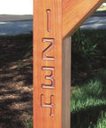 Knockout Sign Making Kit For Router Stencils cut number designs 1 to 4 on a wooden post, showcasing clean routes in hardwood.