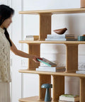 Woman organizing books on Retro Style Floor Standing Book Shelf With Open Multi Layer Shelves For Living Room Or Office