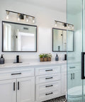 4 Light Bathroom Vanity Light Fixture Modern Black And Gold Sconce Wall Lights Over Mirror With Clear Glass Shades For Powder Room Hallway Easy Install Design That Fits Farmhouse To Mid Century Modern Decor, installed above double mirrors in a modern bathroom.