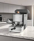 Top Shelf Home Coffee Bean Roaster With Direct Fire Roasting Drum, Rapid Cool Tray, Smart Button Controls, Built In Dust Catcher on kitchen counter.