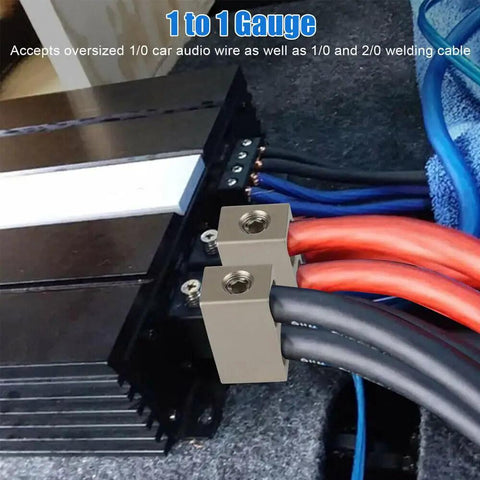 Four Pack Offset 1/0 Gauge Car Audio Power And Ground Reducers For Dual 1/0 To 1/0 Input Aluminum Nickel Plated Heavy Duty Amp Wiring Adapters Compatible With Oversized 1/0 And 2/0 Wire For Install. Shown on car amp with 1/0 and 2/0 cables.