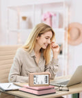 Killer Digital Postal Scale Measures Every Package Up To 66 Pounds With Dead On Precision So You Can Ship Heavy Goods Without Stress While The Sleek Pink Surface Looks Absolutely Dope on a desk with a woman smiling at her laptop.