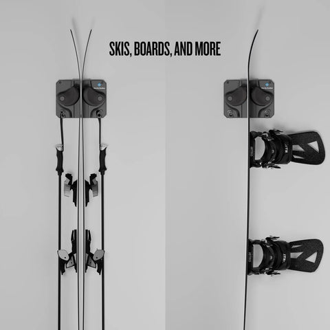 Rugged Black Gravity Lock Ski And Snowboard Wall Mount Rack holding skis and snowboard with poles securely stored, displayed on wall.