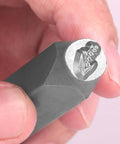 Close-up of a Birth Month Flower Metal Stamping Kit punch stamp held in hand, showing floral design engraving, 5/16 inch size.