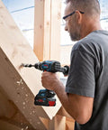 User operating an 18V Cordless Combi Drill with 150 Nm Torque Brushless Motor Pro Grade Power Tool on wooden beams.