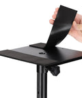 Pole Mount Shelf For 35mm Stands Turns Your DJ Pro Audio Rig Into A Solid Laptop Projector Or Monitor Shelf With A Sturdy 9.45 By 9 Inch Platform And 66 Lb Capacity, showing EVA-lined surface being lifted by hand.