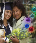 Solar Disco Ball Garden Light With Color Changing LEDs For Outdoor Patio Decor next to a graduate and woman with gift box.