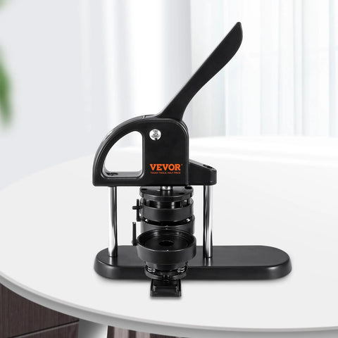 Front view of VEVOR button maker, black plastic body with metal supports and long lever on a table