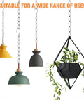 Three colorful pendant lamps and a geometric planter hanging from a chain illustrating versatility in design