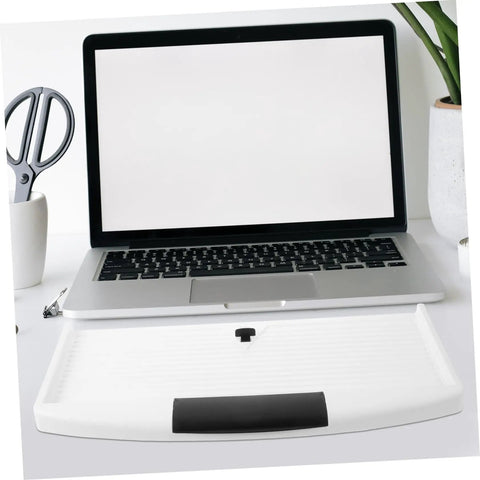 Slick Slide Out Under Desk Keyboard Tray With Heavy Duty Clamp Mount on white desk beside laptop, ensuring ergonomic use.