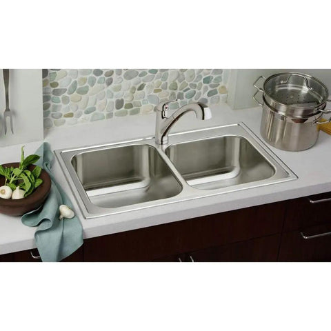 Stainless steel double bowl sink in modern kitchen, includes faucet and counter accessories.