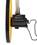 FTVOGUE Distance Measuring Wheel close-up showing yellow wheel and mechanical counter for precise measurements up to 9999.9 M.