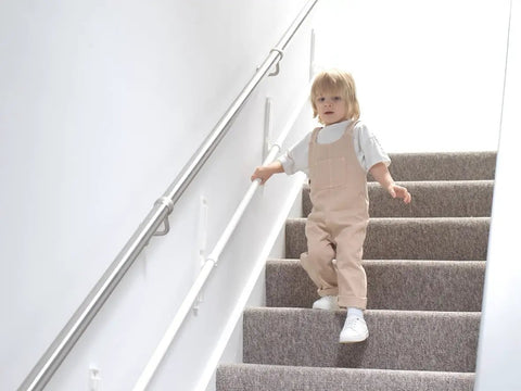 Child using Fully Adjustable Toddler Stair Handrail Built Like A Tank For Little Ones Grows With Your Kid To Deliver Kid Approved Safety And Rock Solid Support Down Each Step Zero Hassle Standard Mount Kit.