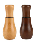Two wooden Espresso Coffee Stirrer Tamper And Leveler Tools with different finishes for clump-free brews and smooth consistency.