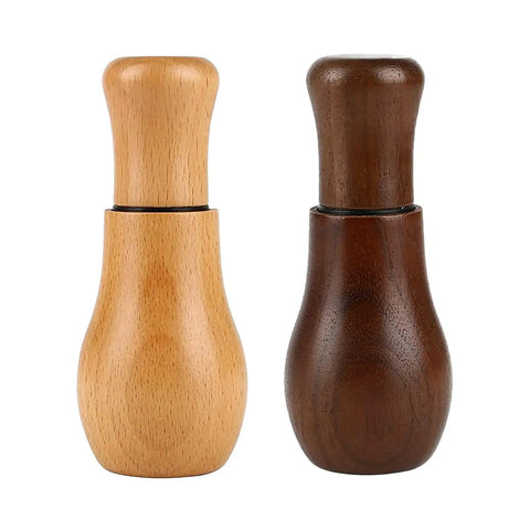 Two wooden Espresso Coffee Stirrer Tamper And Leveler Tools with different finishes for clump-free brews and smooth consistency.